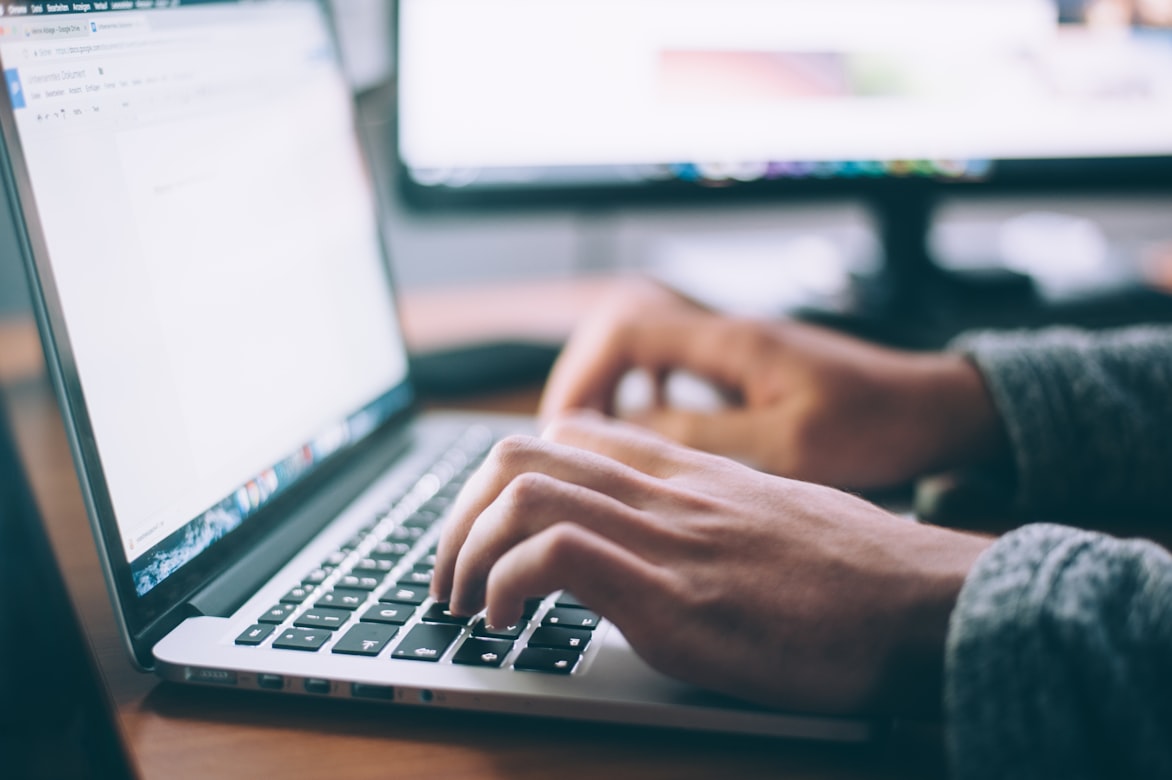 Person researching neighborhoods on laptop