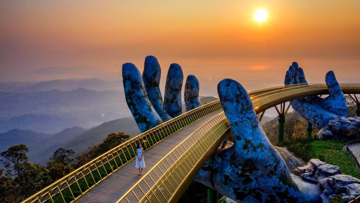 Iconic Golden Bridge with giant stone hands supporting the walkway in Ba Na Hills, Da Nang